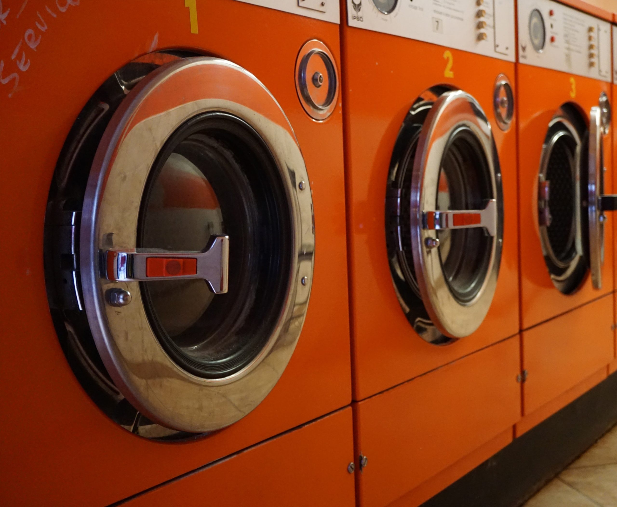 Orange washing machines in a row